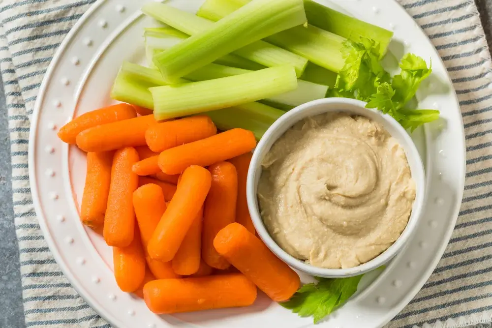 Carrot and celery sticks with hummus.