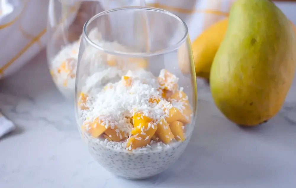 Chia pudding topped with mango and coconut flakes.