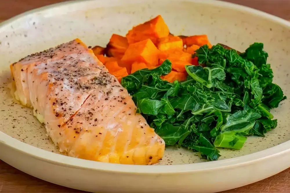 Baked salmon with roasted sweet potatoes and sautéed spinach