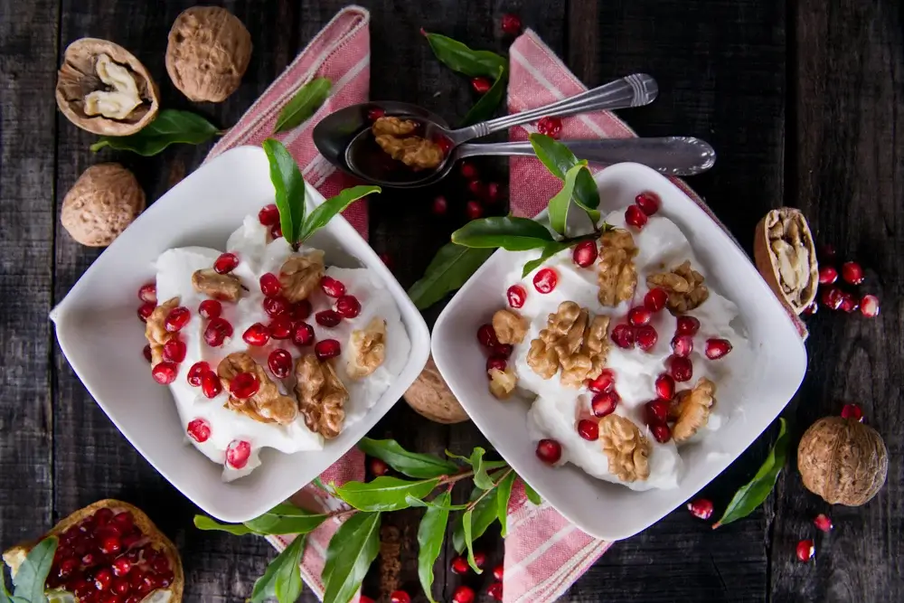 Greek yogurt bowl with walnuts, honey, and pomegranate seeds