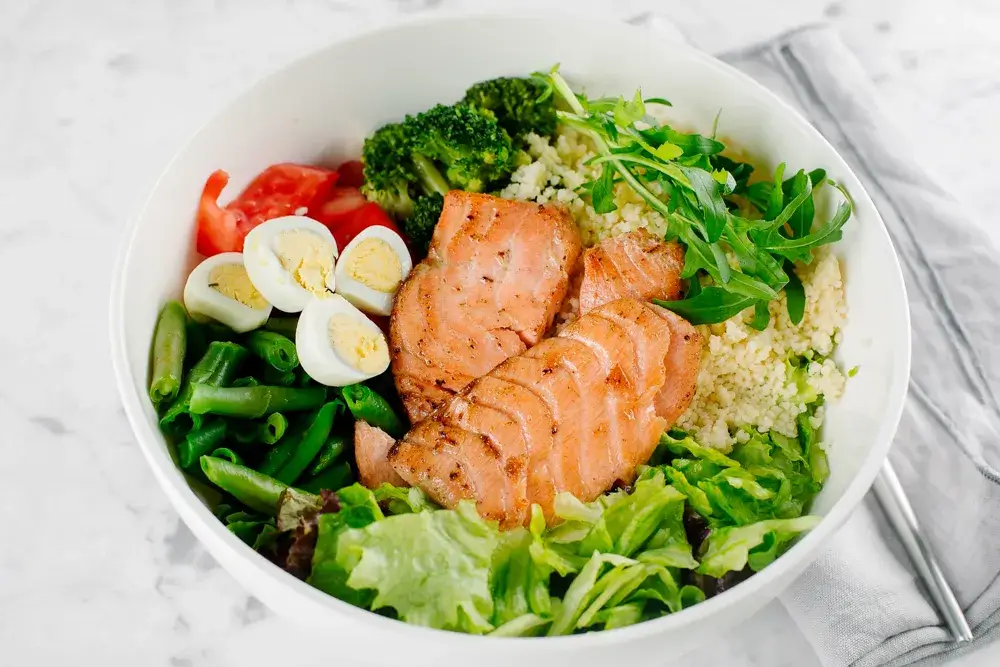 Salmon salad over mixed greens with quinoa